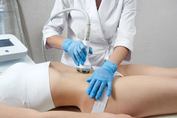 Lost the Weight but Not the Loose Skin? 2 woman having HIFU treatment on her stomach to combat loose skin Amersham following weight loss